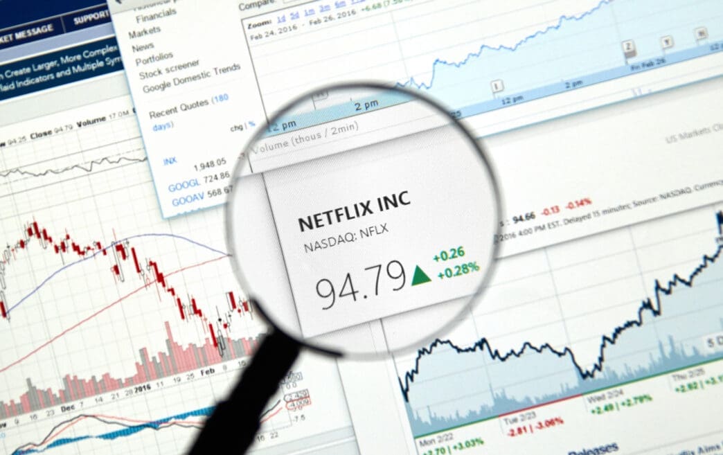 A magnifying glass focuses on Netflix (NFLX) stock information on a financial website.