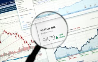 A magnifying glass focuses on Netflix (NFLX) stock information on a financial website.