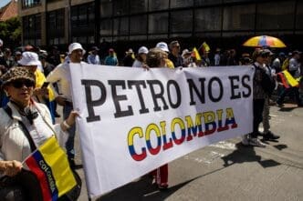 Protesters in Bogota, Colombia, hold a large banner reading "Petro is not Colombia" during a street demonstration.
