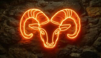 An intense orange-red neon sign illustrating the head of a ram, set against a rough, dark stone wall.