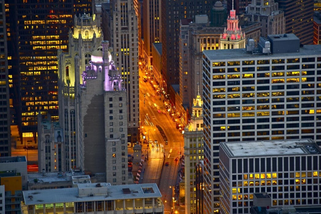 Cityscape at night with illuminated buildings and traffic
