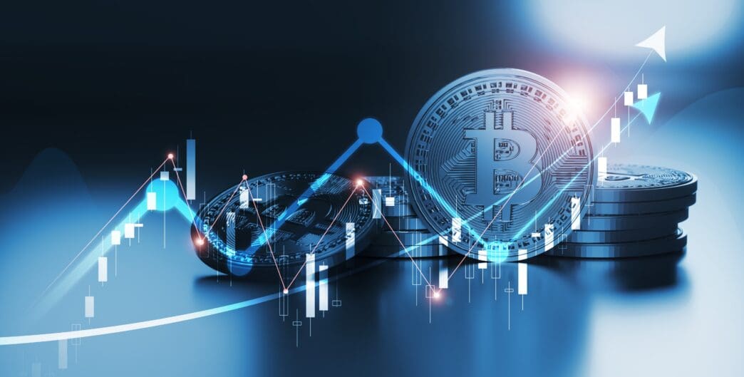 Digital illustration of Bitcoin coins overlaid with a glowing blue financial candlestick chart showing a sharp upward trend