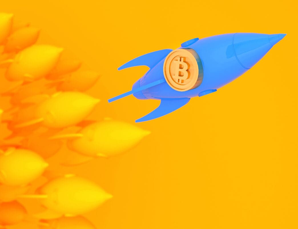 A blue rocket with a Bitcoin symbol soars past yellow rocket shapes
