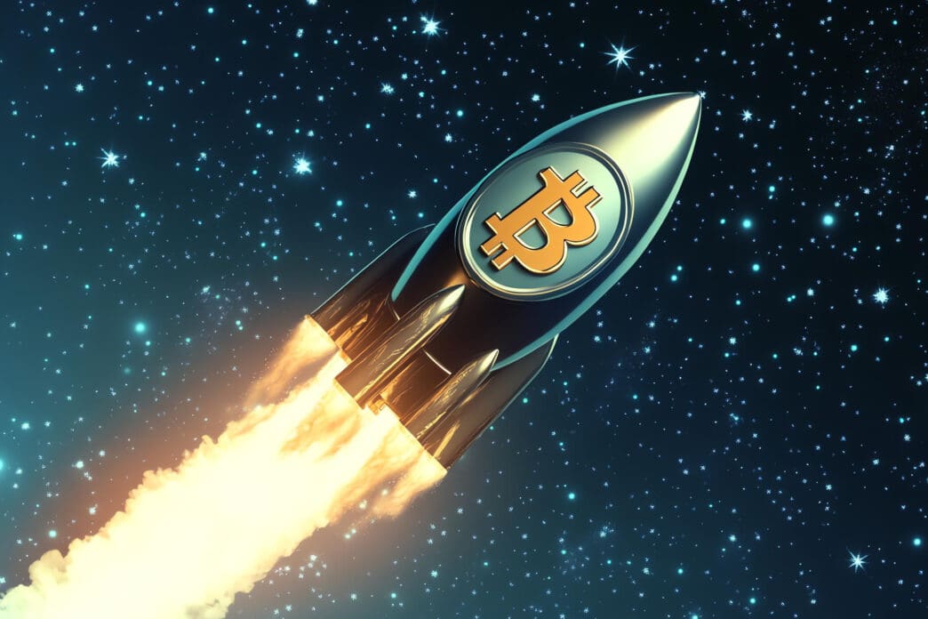 A golden Bitcoin logo adorns a rocket ship blasting off through a starry night sky with fiery exhaust.