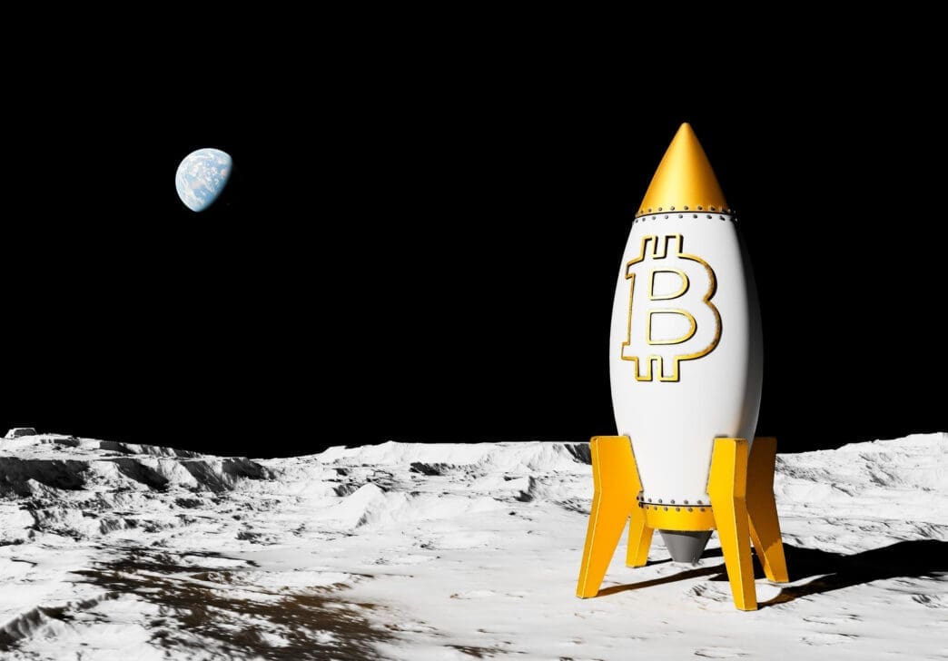 A white rocket with a gold Bitcoin symbol sitting on the Moon's surface, with Earth visible.