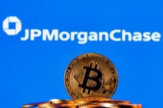 A golden Bitcoin coin on a pile of coins with the JPMorgan Chase logo in the background.