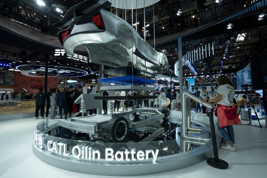 CATL Qilin Battery chassis and a partial car body displayed on a circular platform at the 2024 Beijing Auto Show.