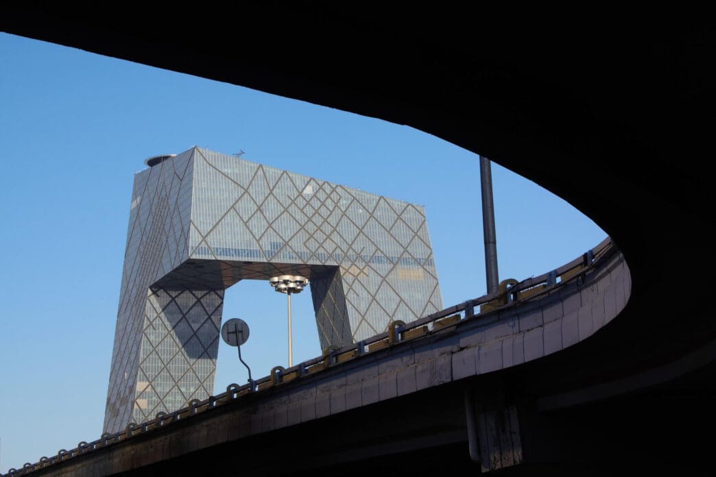 The CCTV Headquarters building in Beijing framed by an overpass