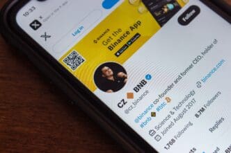 A smartphone screen showing the X (Twitter) profile of Binance co-founder Changpeng Zhao (CZ).