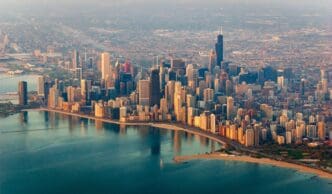 An aerial view of the Chicago skyline along Lake Michigan on a hazy summer day.