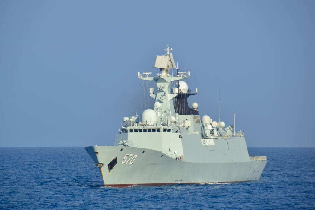 The Chinese Navy's guided-missile frigate PLAN Huangshan (FFG-570) sailing on calm blue open water.