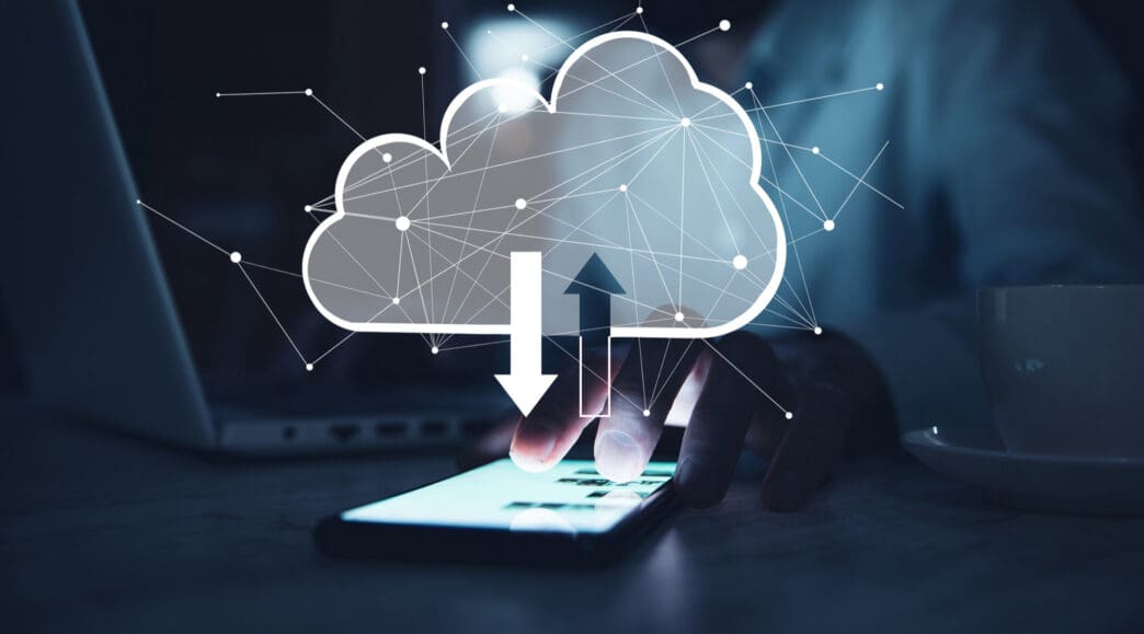 A person uses a smartphone with a cloud icon and network lines overhead