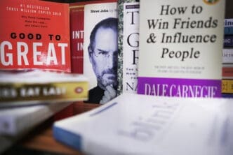 A close-up of several business books, including "Good to Great" and "How to Win Friends & Influence People"