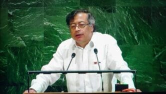 Gustavo Petro, President of Colombia, stands at a podium in a white shirt, addressing the United Nations General Assembly.