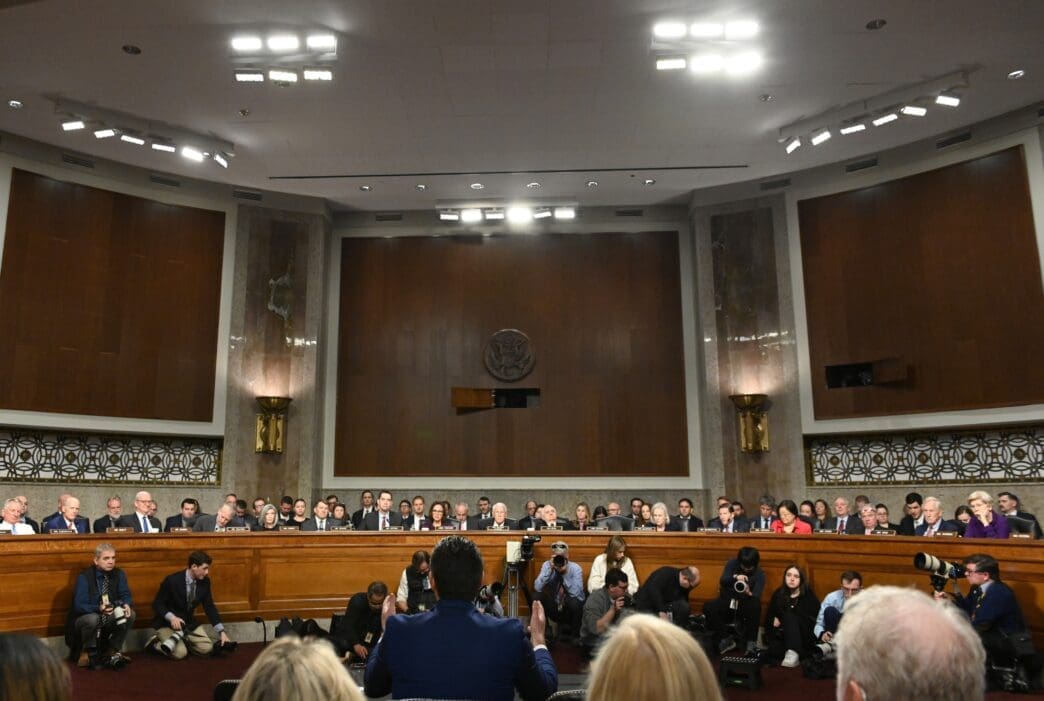 Wide shot of the Senate Armed Services Committee hearing room with the nominee and senators.