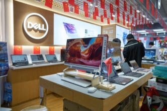 A Dell computer kiosk inside the Seg Electronics Market in Shenzhen, China, with laptops on display and Chinese flags hanging.