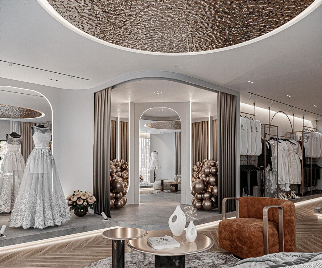 Interior of a luxurious bridal shop with white wedding gowns on mannequins.