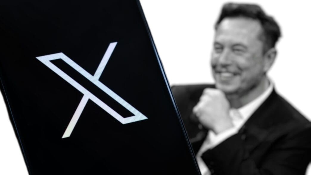 The 'X' logo of the social media platform on a black smartphone screen, with a blurred, smiling Elon Musk in the background.