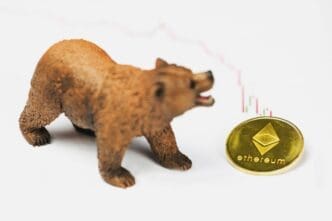 A bear figurine, an Ethereum coin, and a declining financial chart symbolize a bear market.