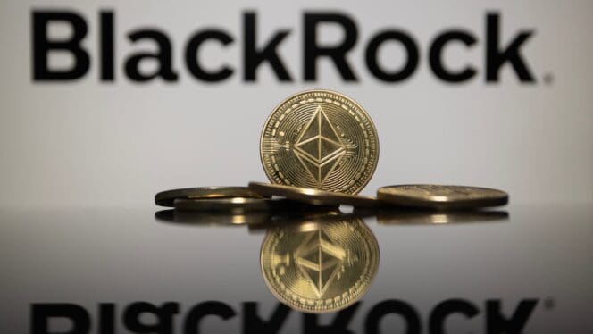 A physical Ethereum (ETH) coin stands reflected in front of the BlackRock logo.