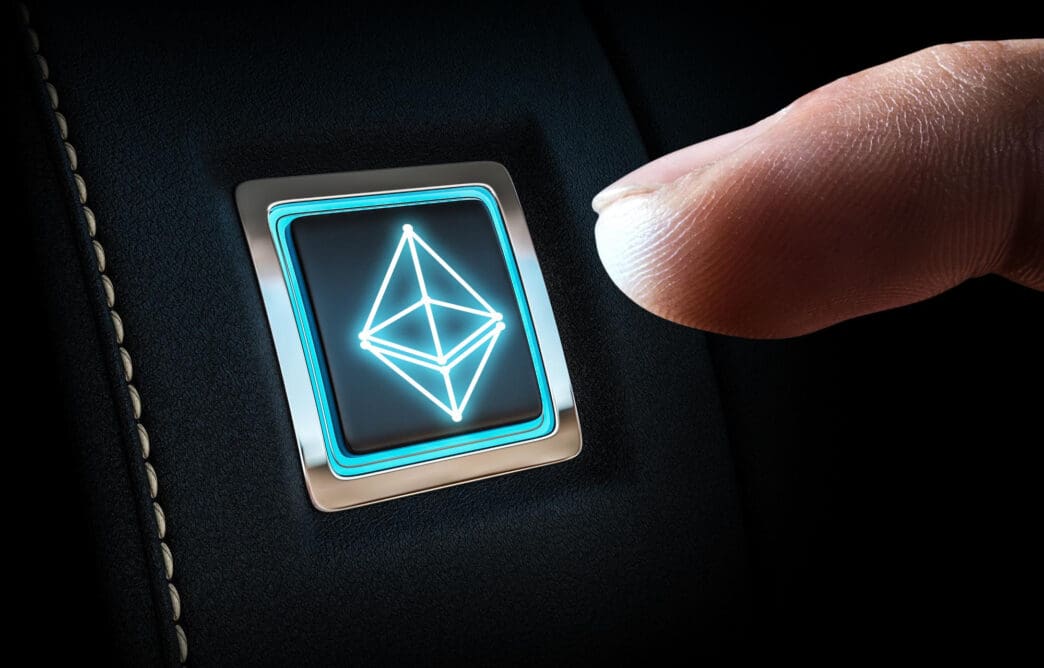 A person's finger about to press a glowing button with the Ethereum crypto logo.