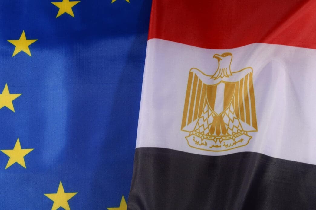 A close-up of the flags of the European Union and Egypt positioned side-by-side, symbolizing their diplomatic relationship.