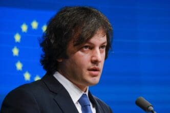 Georgian Prime Minister Irakli Kobakhidze speaks at a press conference with EU flags