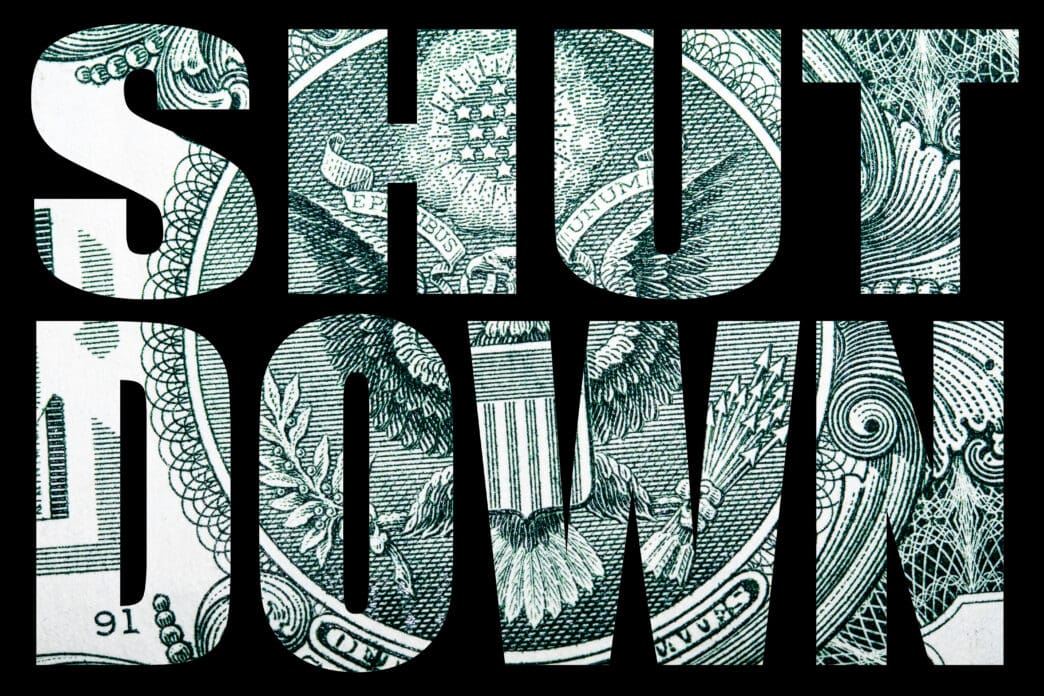 The words "SHUT DOWN" are shown with the US dollar bill's eagle design as a fill.