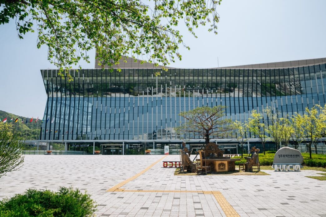 The modern glass facade of the HICO convention center in Gyeongju, South Korea.