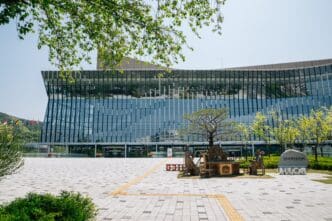 The modern glass facade of the HICO convention center in Gyeongju, South Korea.