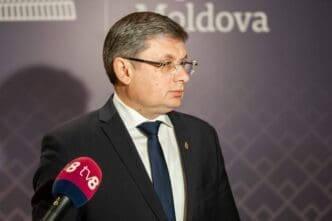 Igor Grosu speaks into a microphone during a media interview