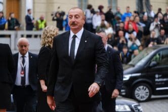 Ilham Aliyev, President of Azerbaijan, walks with security and onlookers in the background