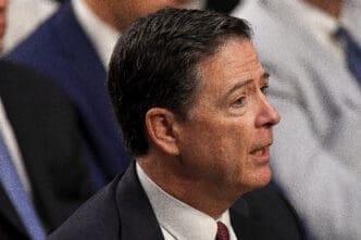 Profile close-up of James Comey, former FBI Director, speaking during a high-stakes Senate committee hearing