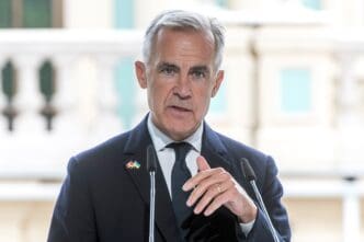 Canadian Prime Minister Mark Carney speaks at a podium during a press conference.