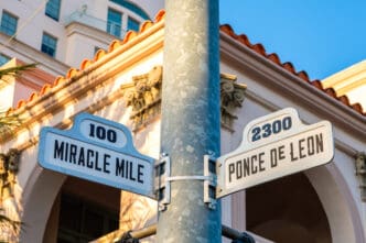 Street signs for Miracle Mile and Ponce de Leon in Coral Gables, Florida.