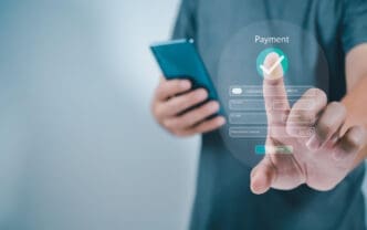 Person uses a smartphone to fill out a payment form with a checkmark icon
