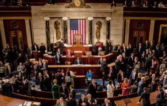 An overhead view of the U.S. House of Representatives chamber, filled with members of the 115th Congress and their families mingling.