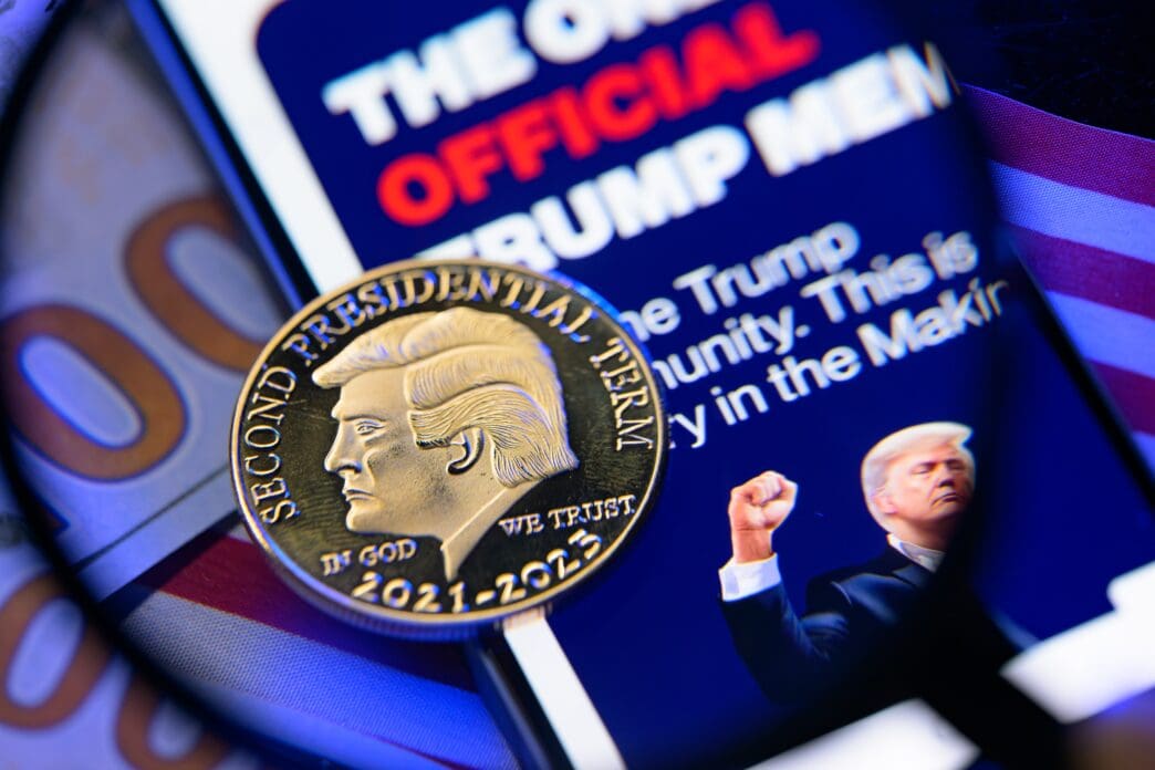 A photo illustration of a $Trump meme coin on a phone and dollar bill.