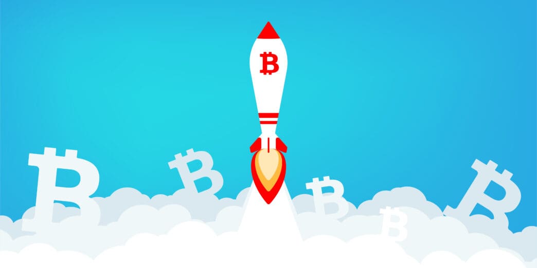 Bitcoin rocket launching through clouds against a blue sky