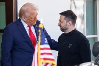 President Donald Trump speaks with Ukrainian President Volodymyr Zelenskyy at the White House, with his hand on Zelenskyy's arm.