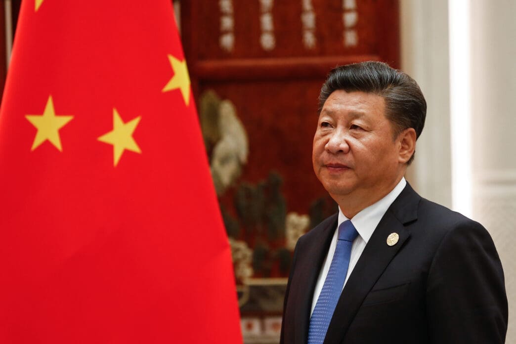Chinese President Xi Jinping stands next to the flag of China during the G20 summit in Hangzhou.