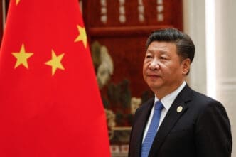 Chinese President Xi Jinping stands next to the flag of China during the G20 summit in Hangzhou.