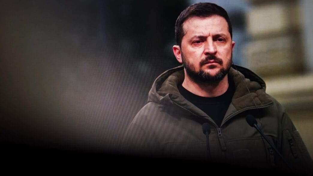 President Volodymyr Zelenskyy of Ukraine speaks at a podium with microphones