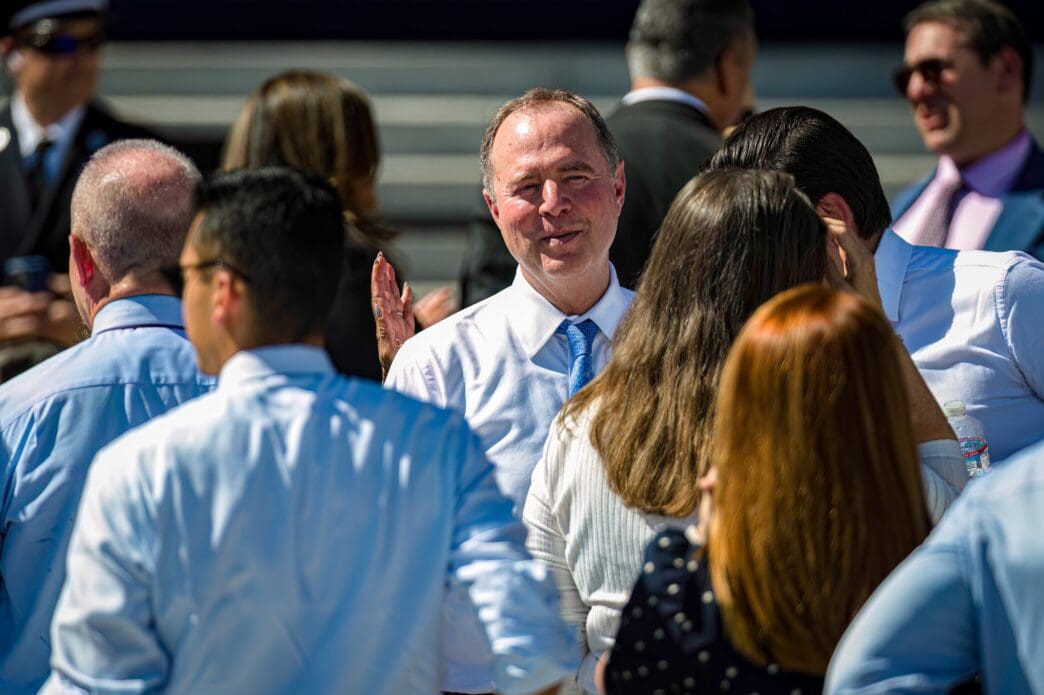 Representative Adam Schiff smiles while speaking with people at an event in San Francisco.