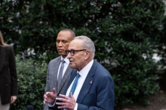 Senate Minority Leader Chuck Schumer speaks to press, with House Minority Leader Hakeem Jeffries behind him