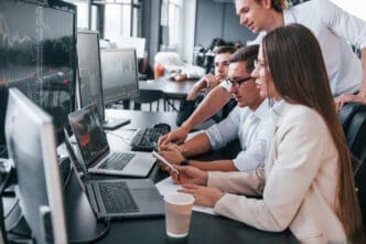Team looking at financial data on computers in an office