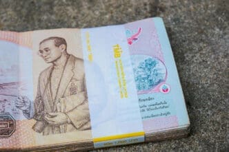Stack of Thai Baht banknotes with a portrait of a king