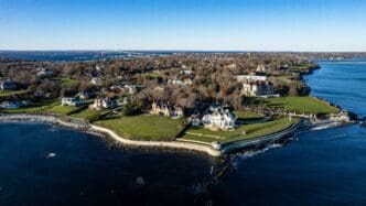 High-resolution drone photo of The Breakers mansion and other luxurious properties on the rocky coastline of Newport, Rhode Island.