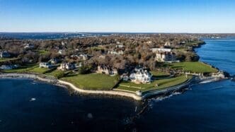 High-resolution drone photo of The Breakers mansion and other luxurious properties on the rocky coastline of Newport, Rhode Island.