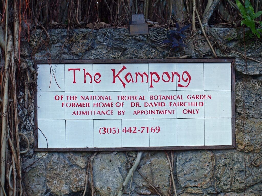 A tiled sign for The Kampong, the former home of Dr. David Fairchild, set in a stone wall in Miami.